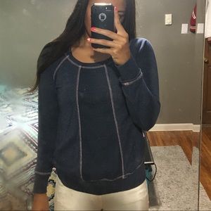 Long sleeve sweater with floral lace down middle.